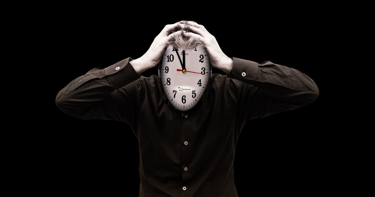 Person in a black shirt holding their head with a large clock replacing their face against a dark background, symbolizing stress, burnout, time pressure, and feeling overwhelmed.
