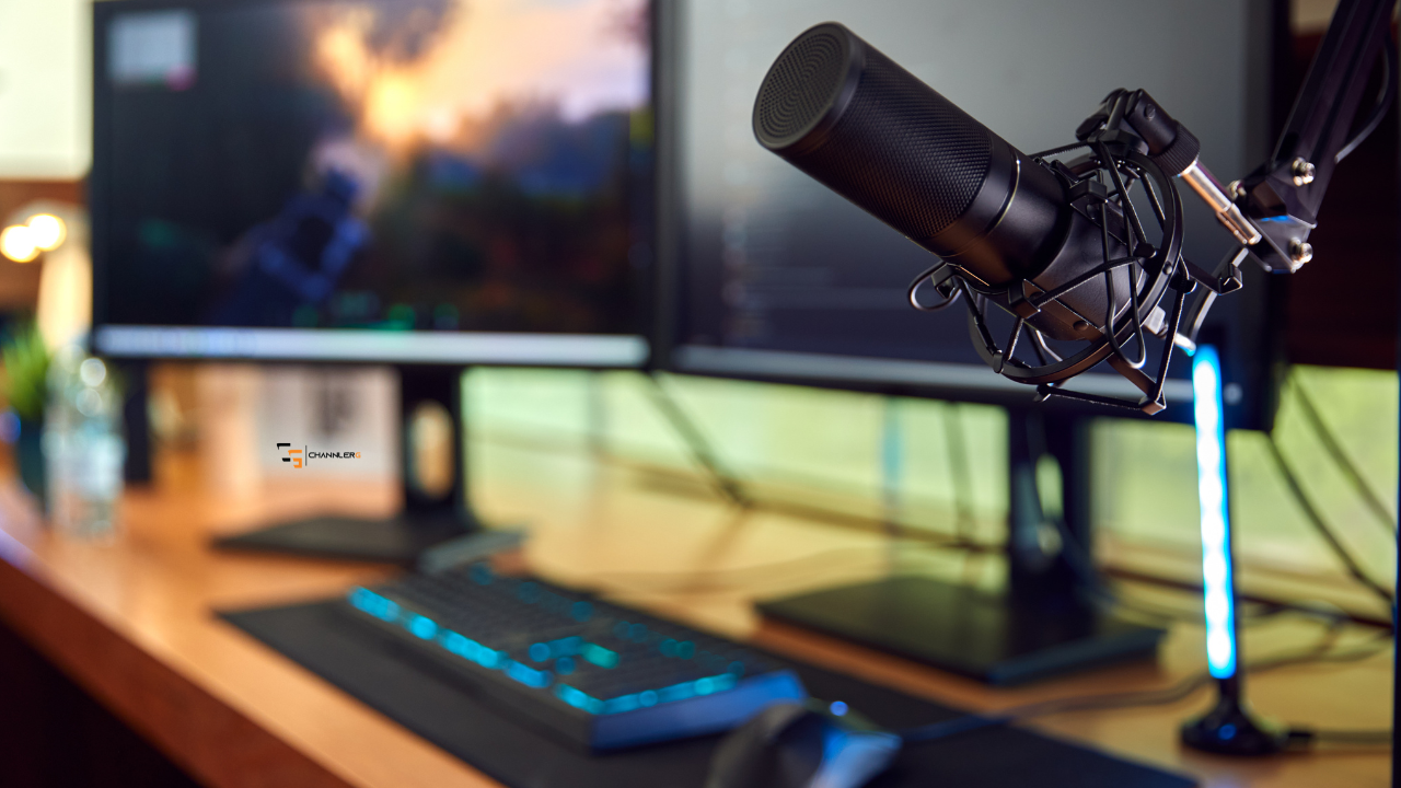 Streaming microphone on a boom arm in front of a dual-monitor gaming and content creation setup.