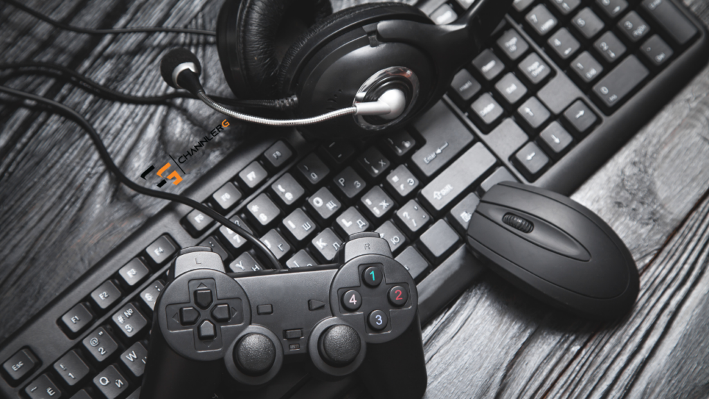 Gaming setup with controller, headset, keyboard, and mouse on a wooden desk.