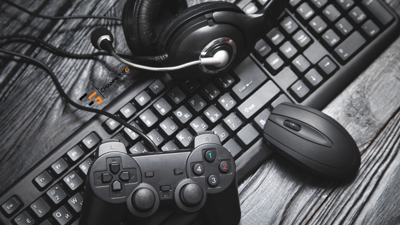 Gaming setup with controller, headset, keyboard, and mouse on a wooden desk.