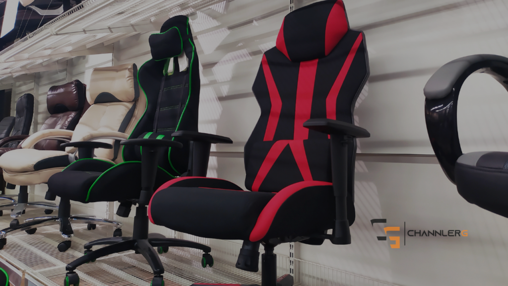 Row of gaming and office chairs displayed in a showroom, including black and red racing-style gaming chairs.