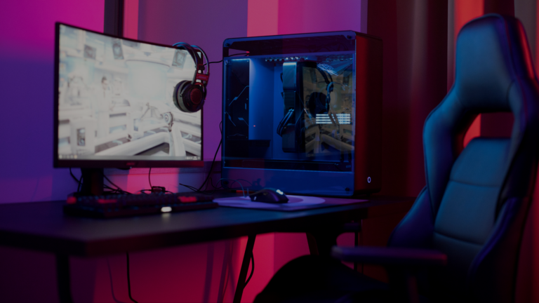 RGB-lit gaming setup with curved monitor, open glass PC case, and black gaming chair