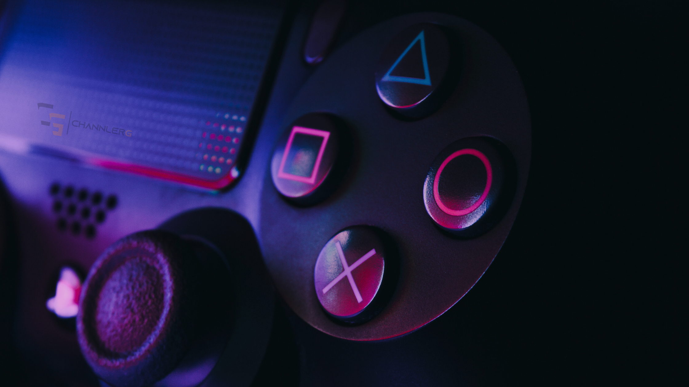 Close-up of a PlayStation controller illuminated with neon pink and blue lighting, highlighting the iconic triangle, circle, square, and X buttons.