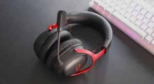 HyperX gaming headset with boom microphone placed next to a white RGB mechanical keyboard.