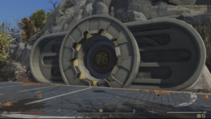 Vault 76 entrance door built into rocky mountainside in Fallout 76, showing large circular vault door with “76” at the center.