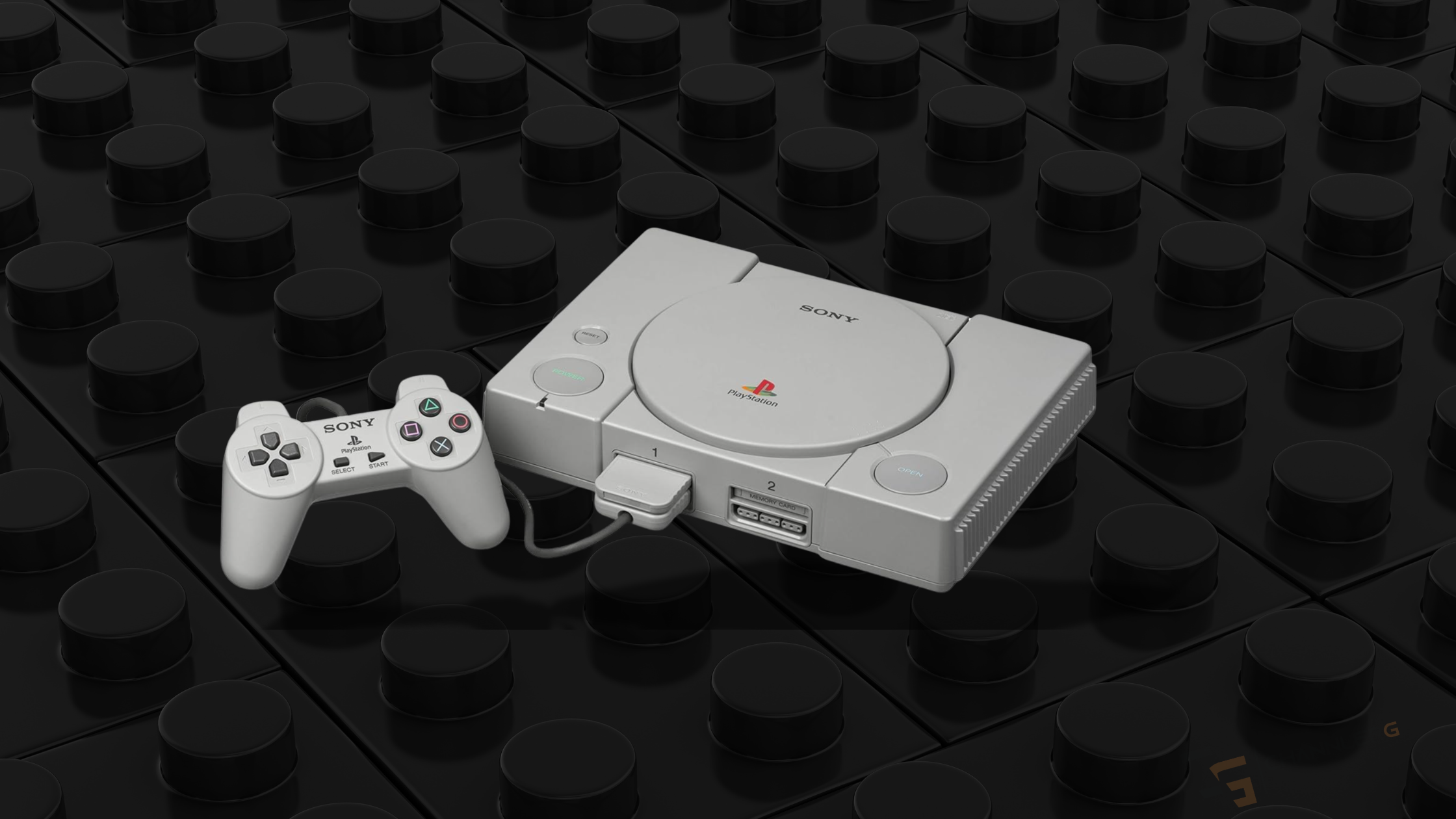 Original Sony PlayStation 1 console with classic controller displayed on a LEGO-style studded background.