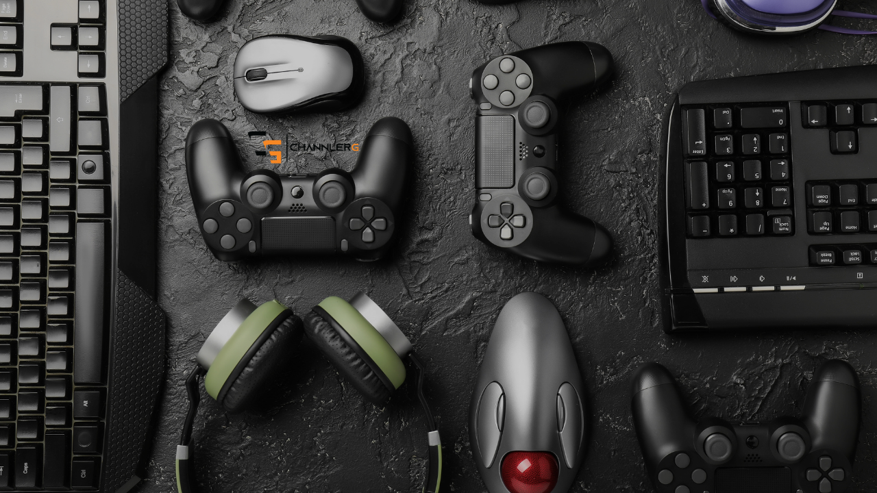 Flat lay of gaming setup with controllers, keyboard, mouse, and headset on a dark textured desk surface.