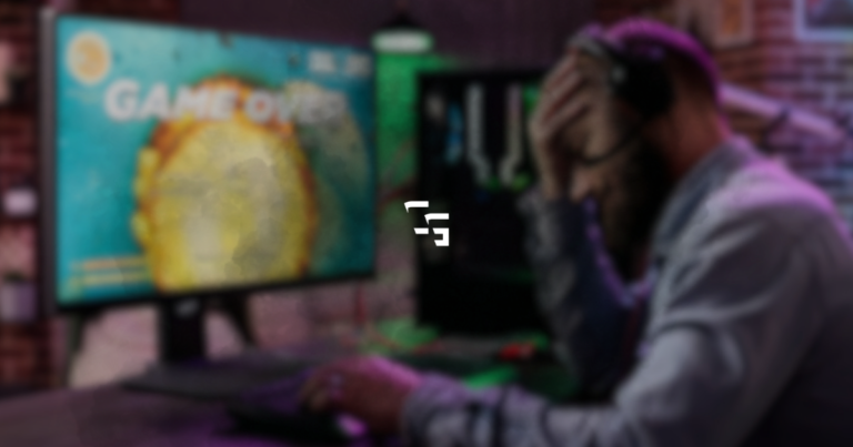 Frustrated gamer sitting at a PC with their head in their hand while a monitor displays a game over screen, representing gaming frustration, losing streaks, and burnout.
