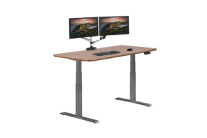Vari electric standing desk with a walnut desktop, dual-monitor arm, and ergonomic workstation for a home office.