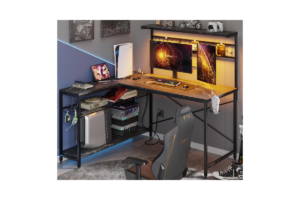 Bestier 51-inch corner gaming desk with dual monitors, storage shelves, LED lighting, and console setup