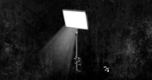 NEEWER LED key light with desk clamp on a colorful gaming background