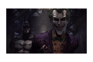 The Joker grinning in the foreground with Batman standing behind him in a dark scene from Batman: Arkham Asylum.